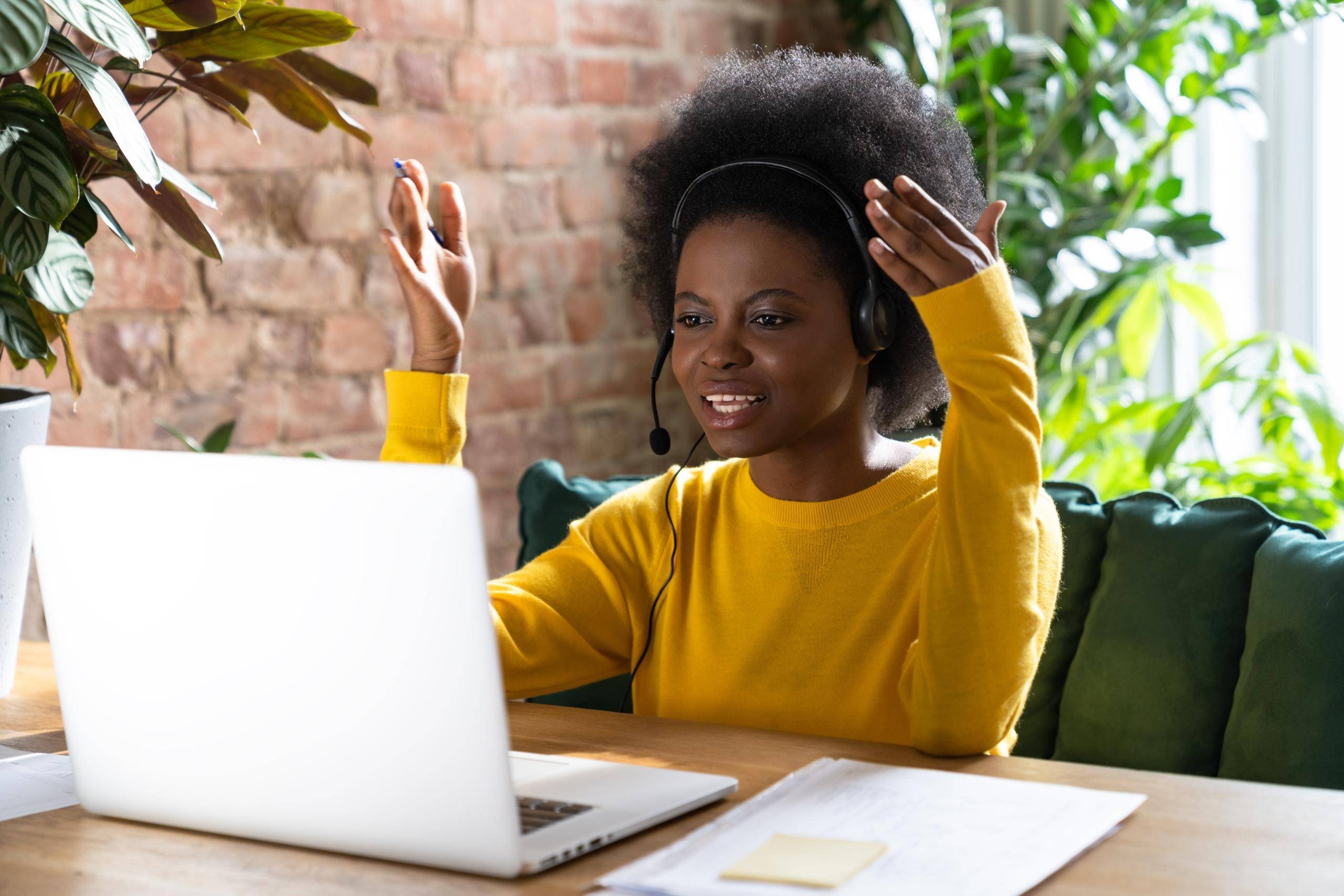 focused-black-woman-employee-wear-headphones-talki-FT8VDS2